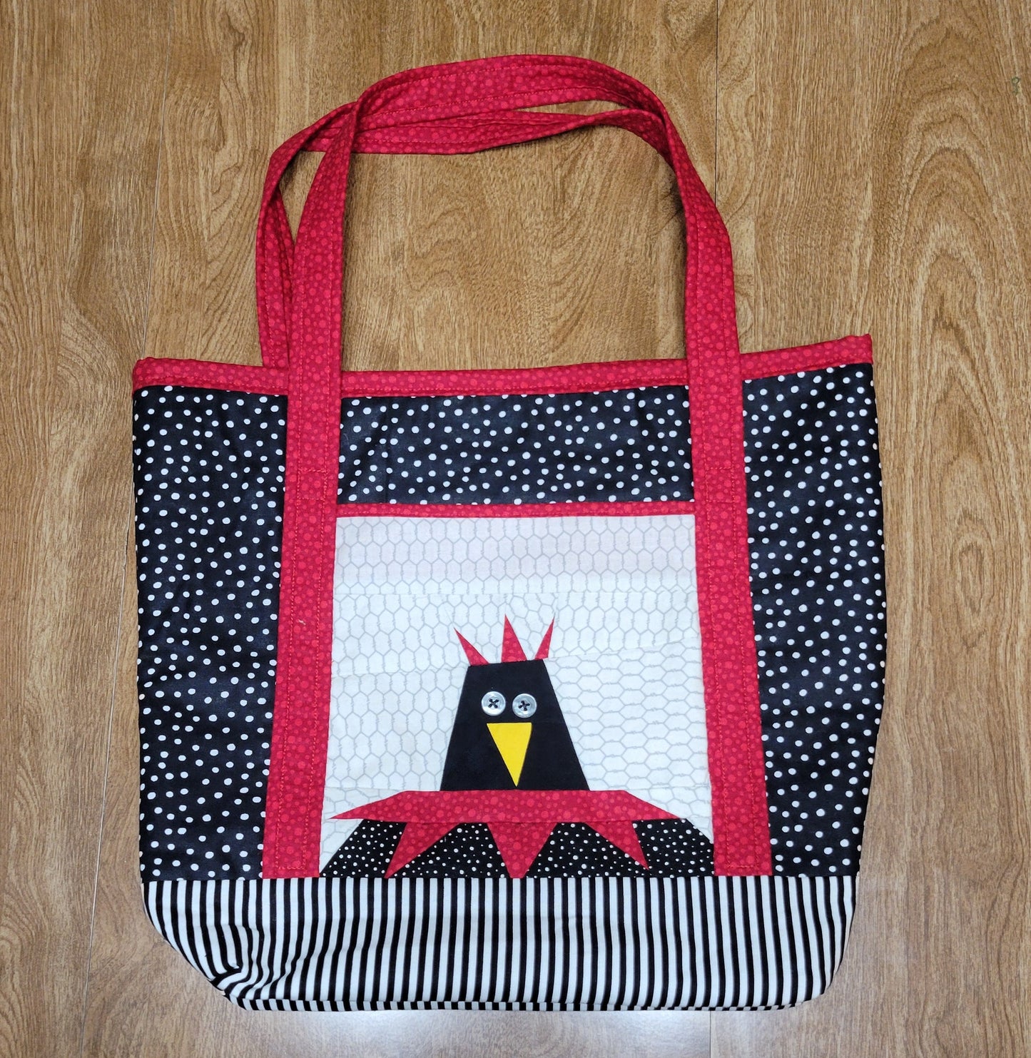 Handmade bag with a bird design on a wooden surface