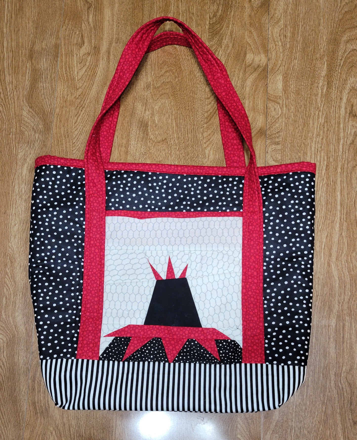 Fabric bag with a black and white pattern on a wooden surface