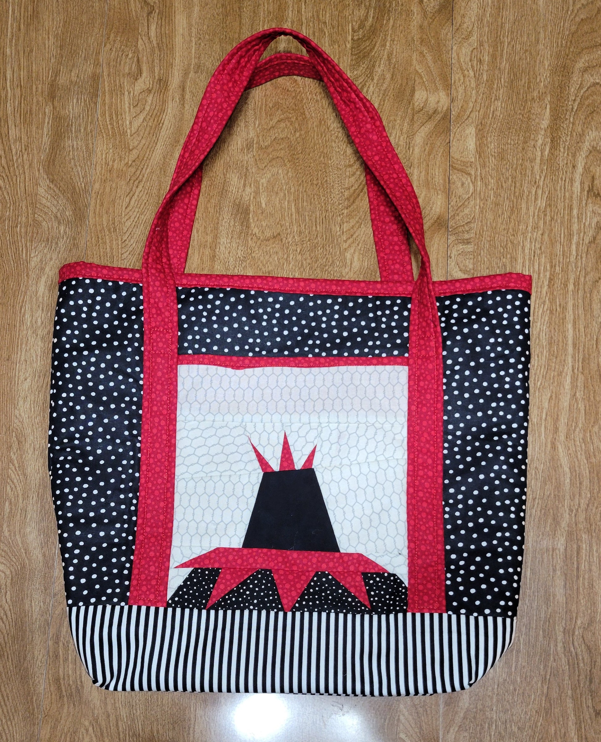 Fabric bag with a black and white pattern on a wooden surface