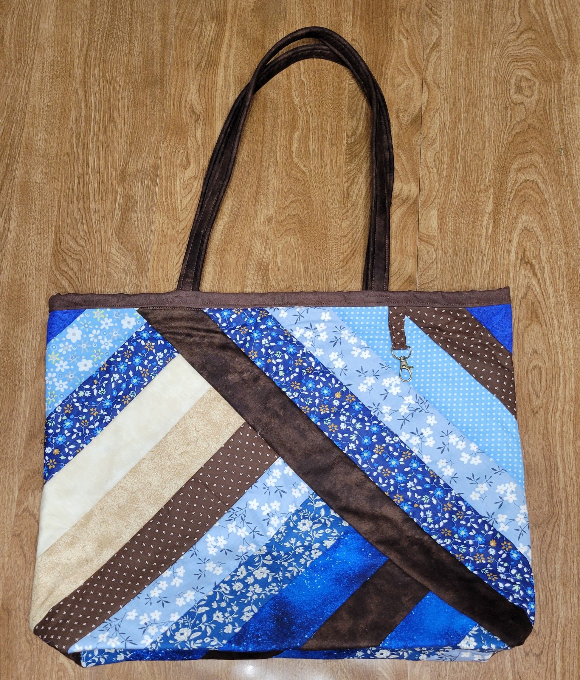 Patchwork bag with blue and brown pattern on a wooden surface