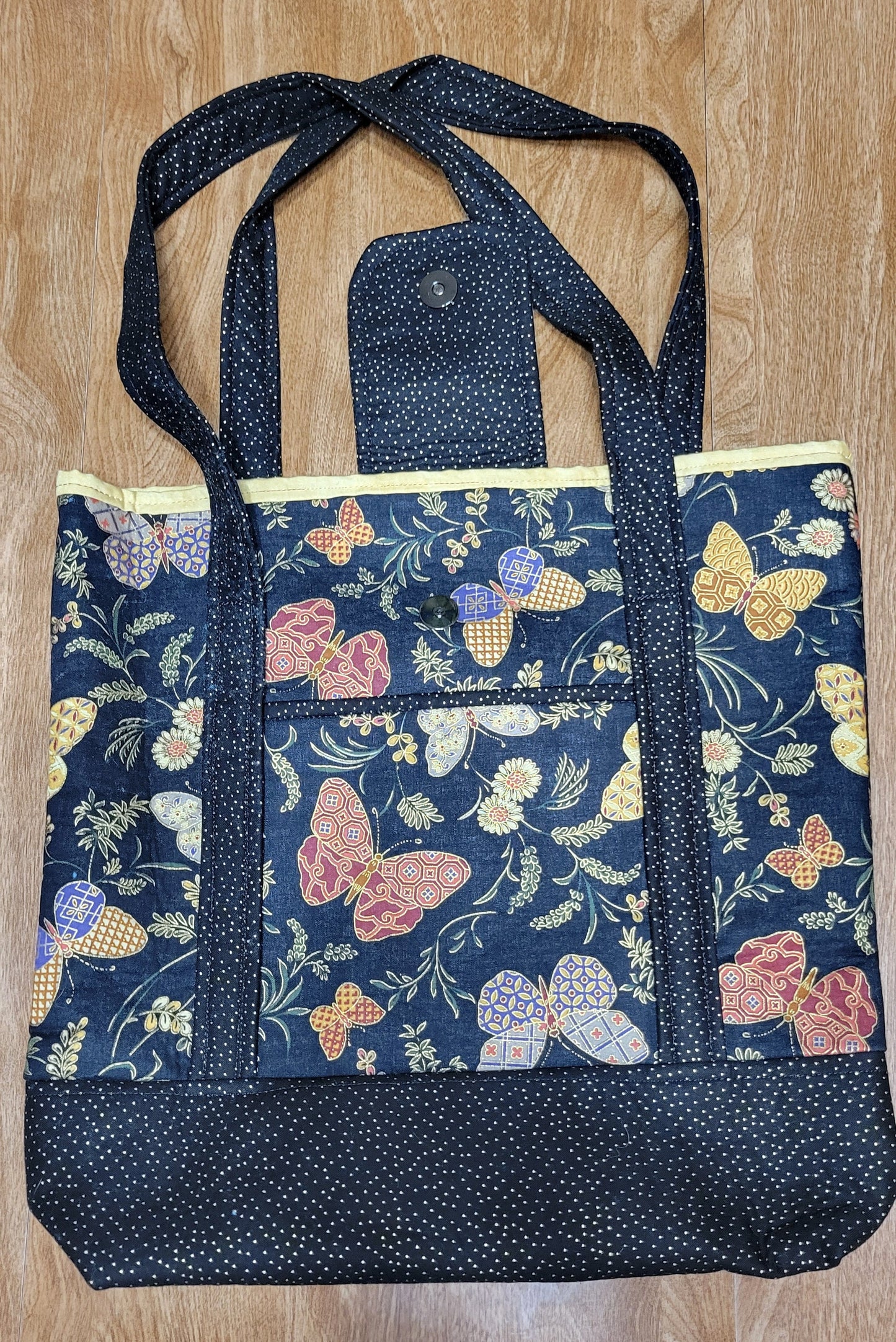 Bag with a butterfly pattern on a wooden surface