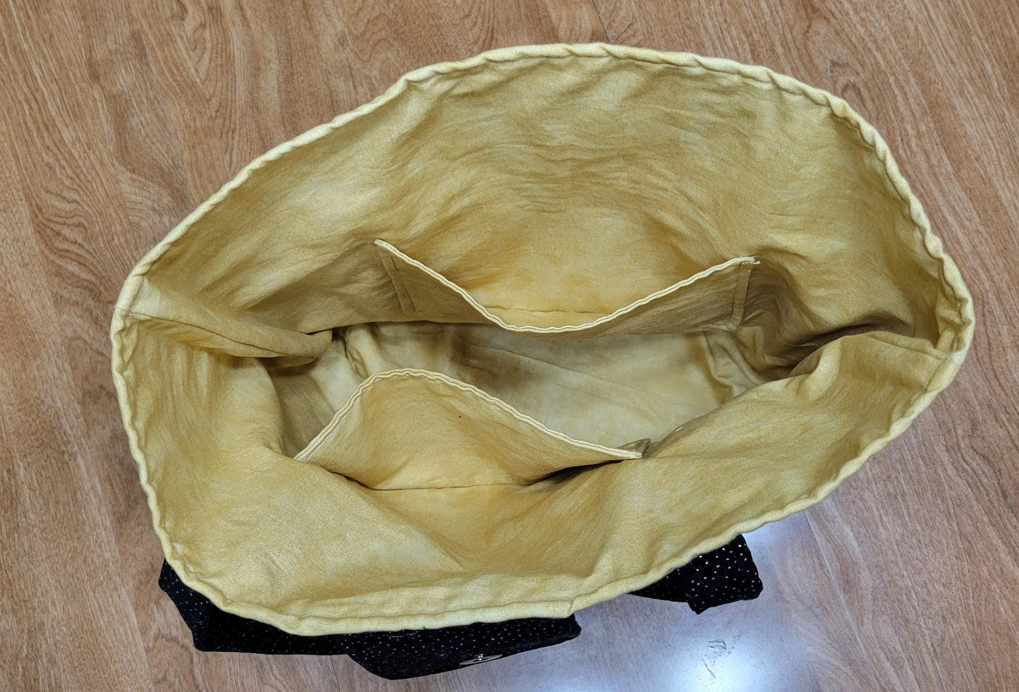 Yellow bag on a wooden background