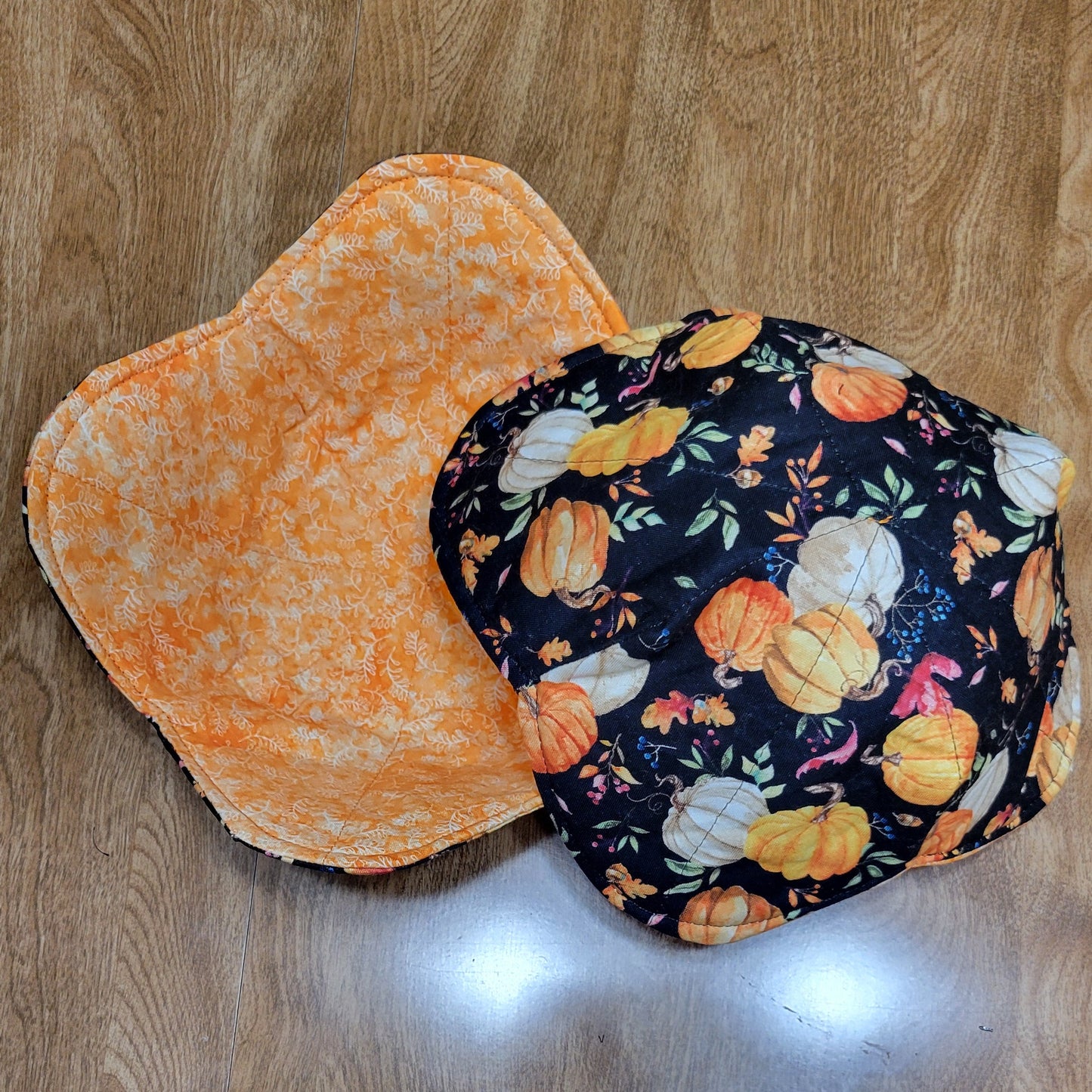 Pumpkin - patterned fabric with the inside lined with a orange fabric on a wooden surface