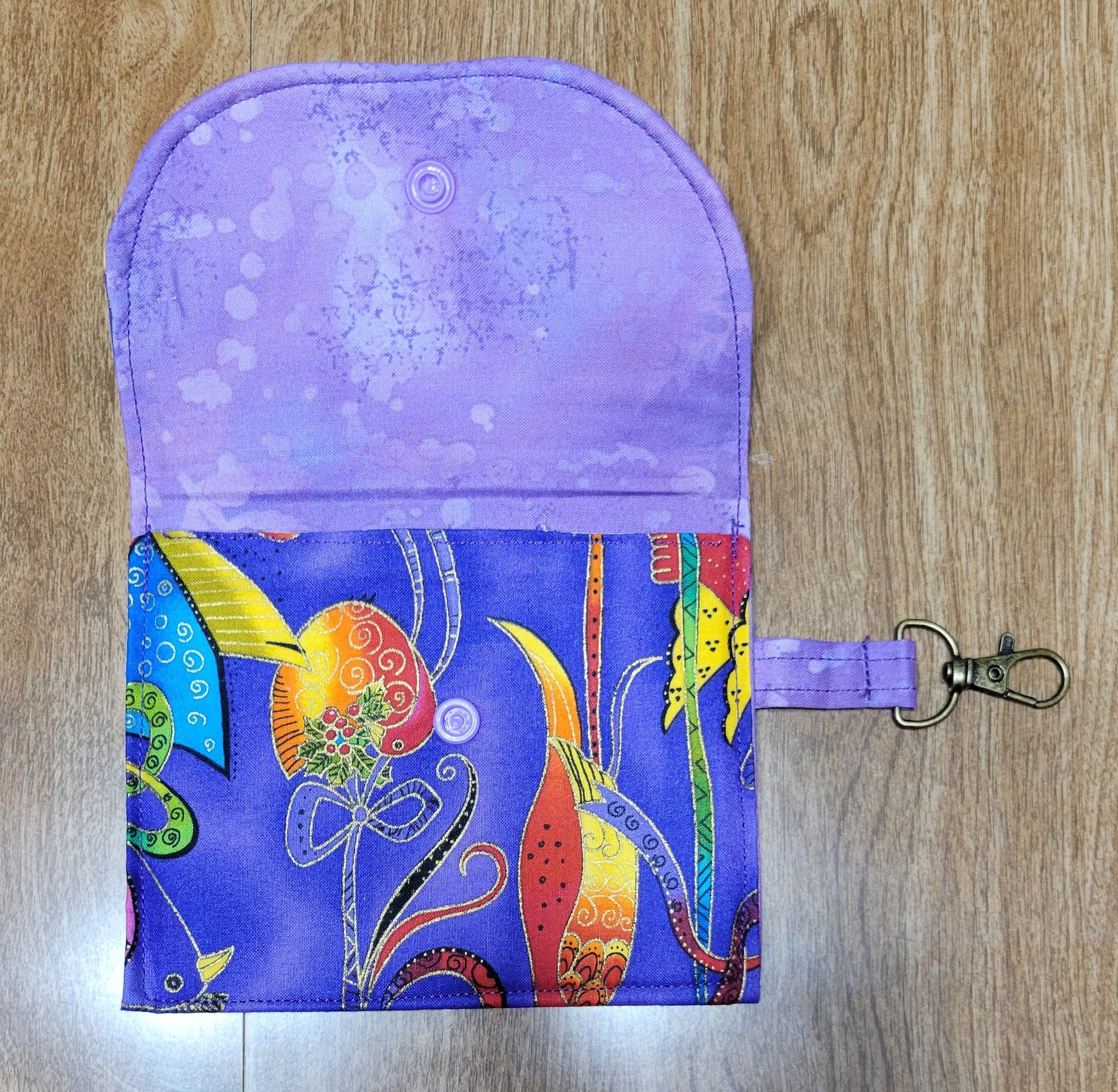 Small pouch with a colorful design on a wooden surface