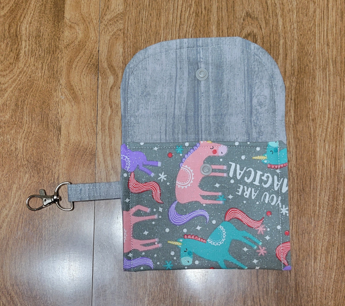 Small pouch with colorful designs on a wooden surface