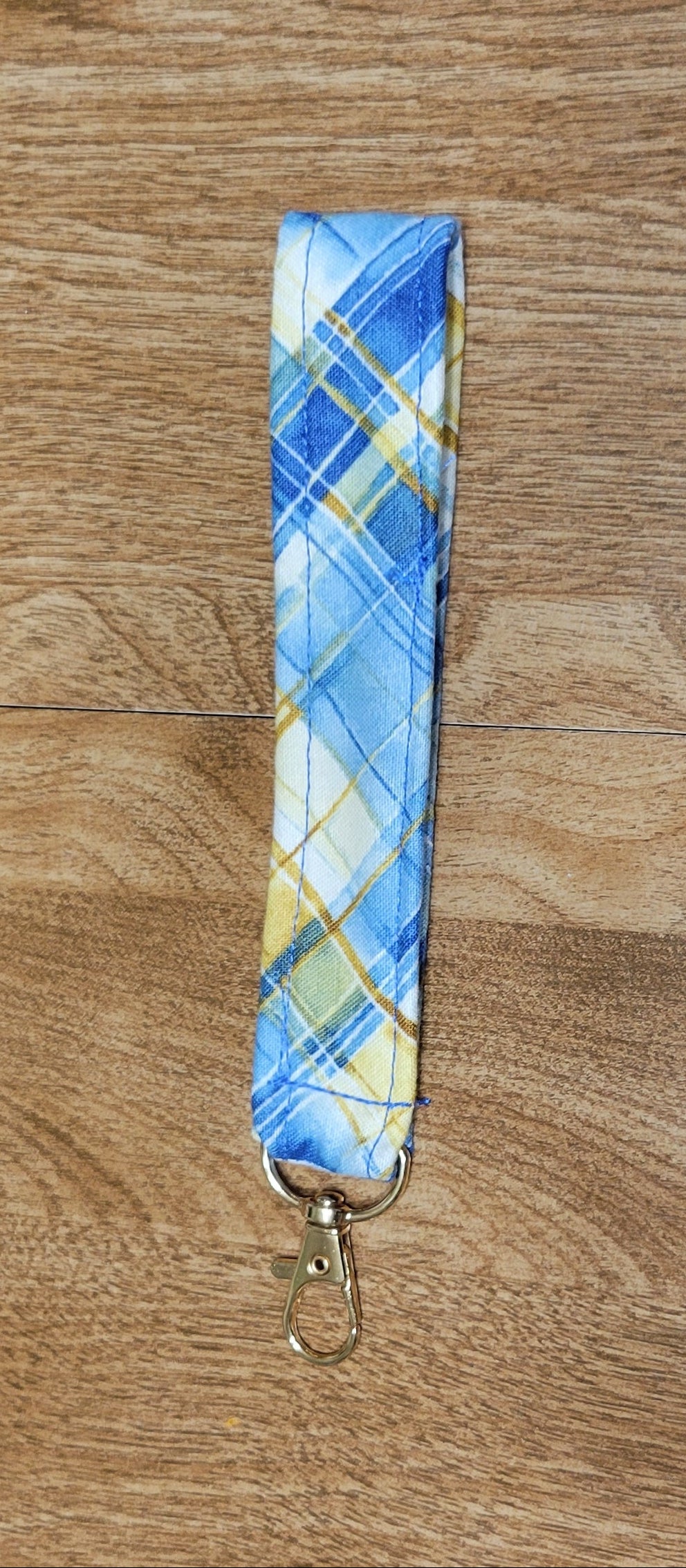 Plaid patterned strap on a wooden surface