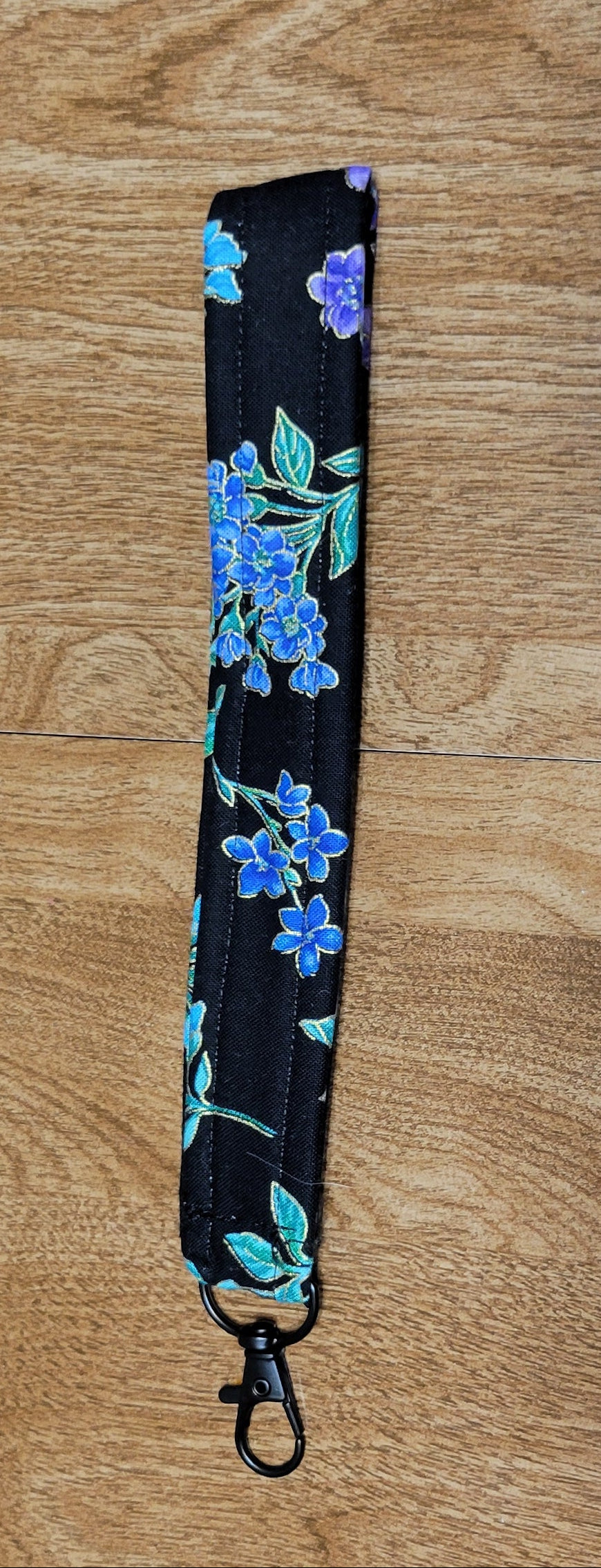 Floral-patterned strap on a wooden surface