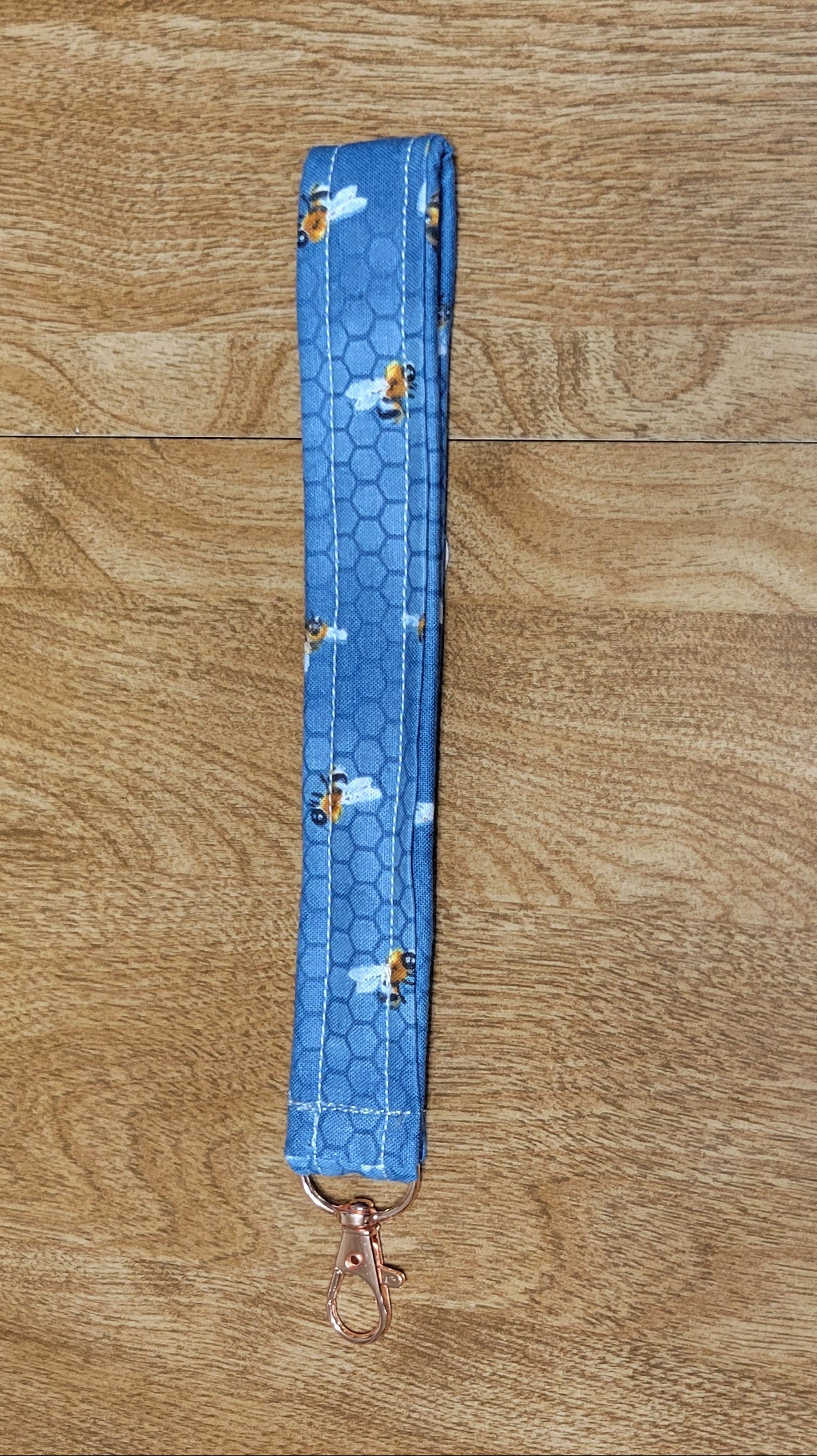 Blue material with bees on a wooden floor