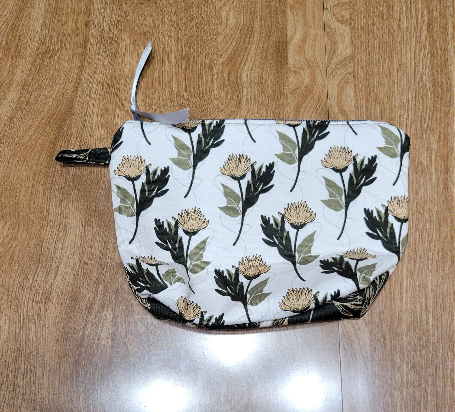 Floral-patterned make-up bag on a wooden surface
