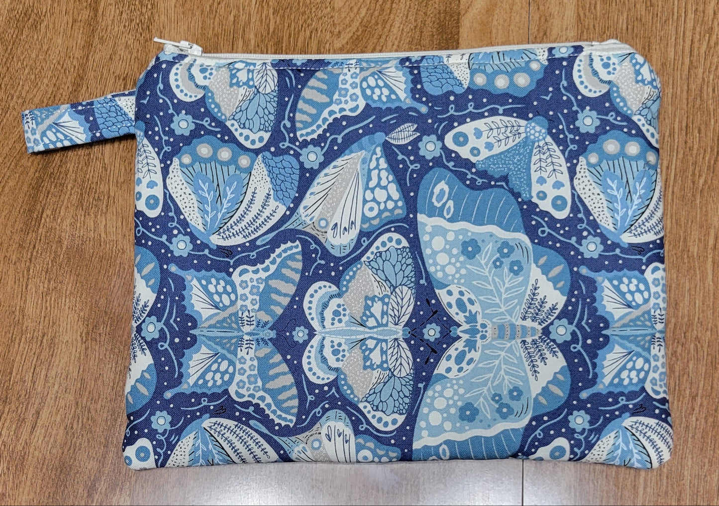 Blue and white butterfly-patterned fabric on a wooden surface