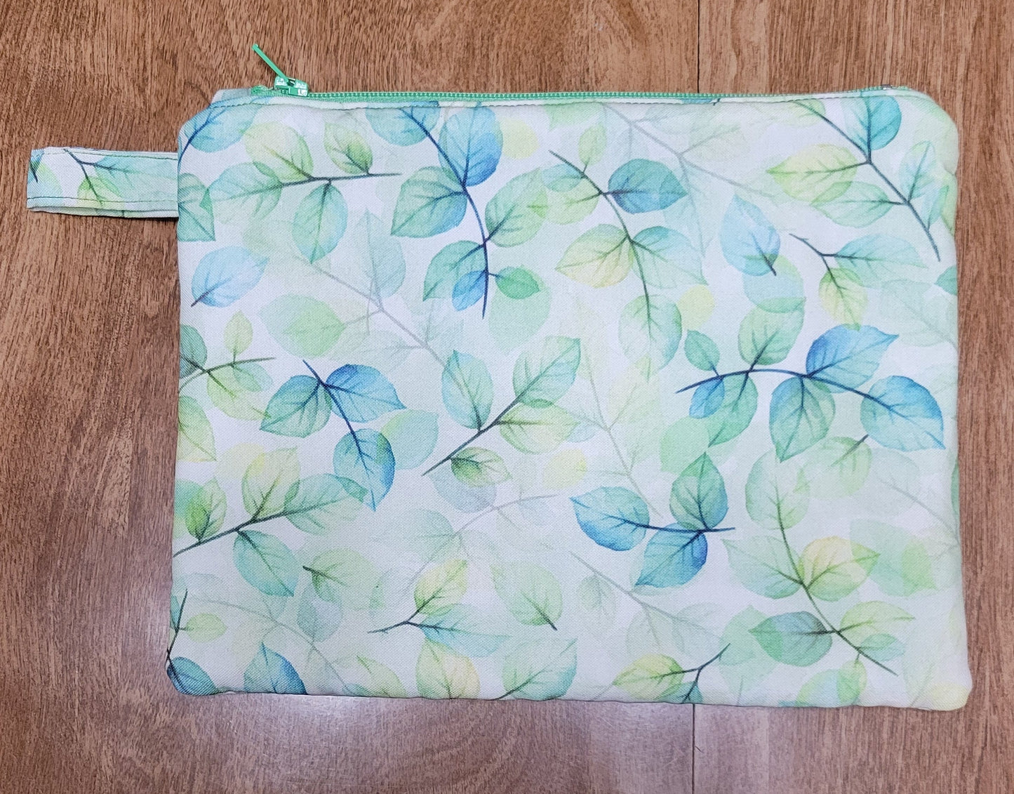 Leaf-patterned pouch on a wooden surface