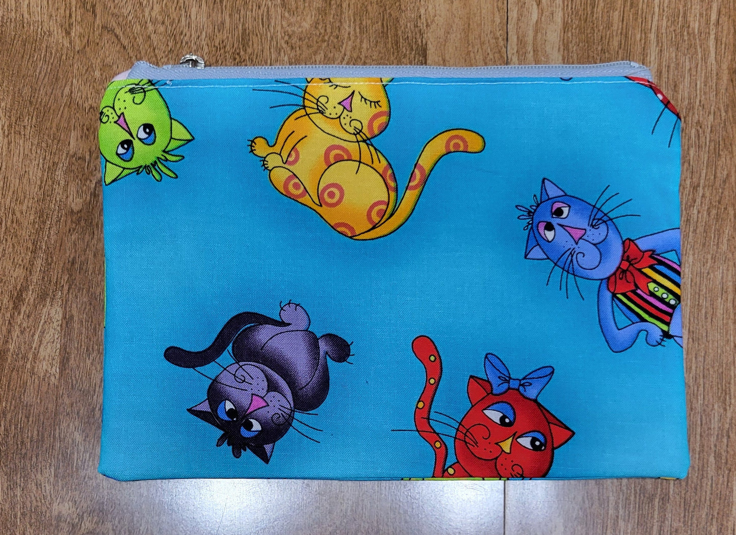 Colorful cat-patterned fabric on a wooden surface