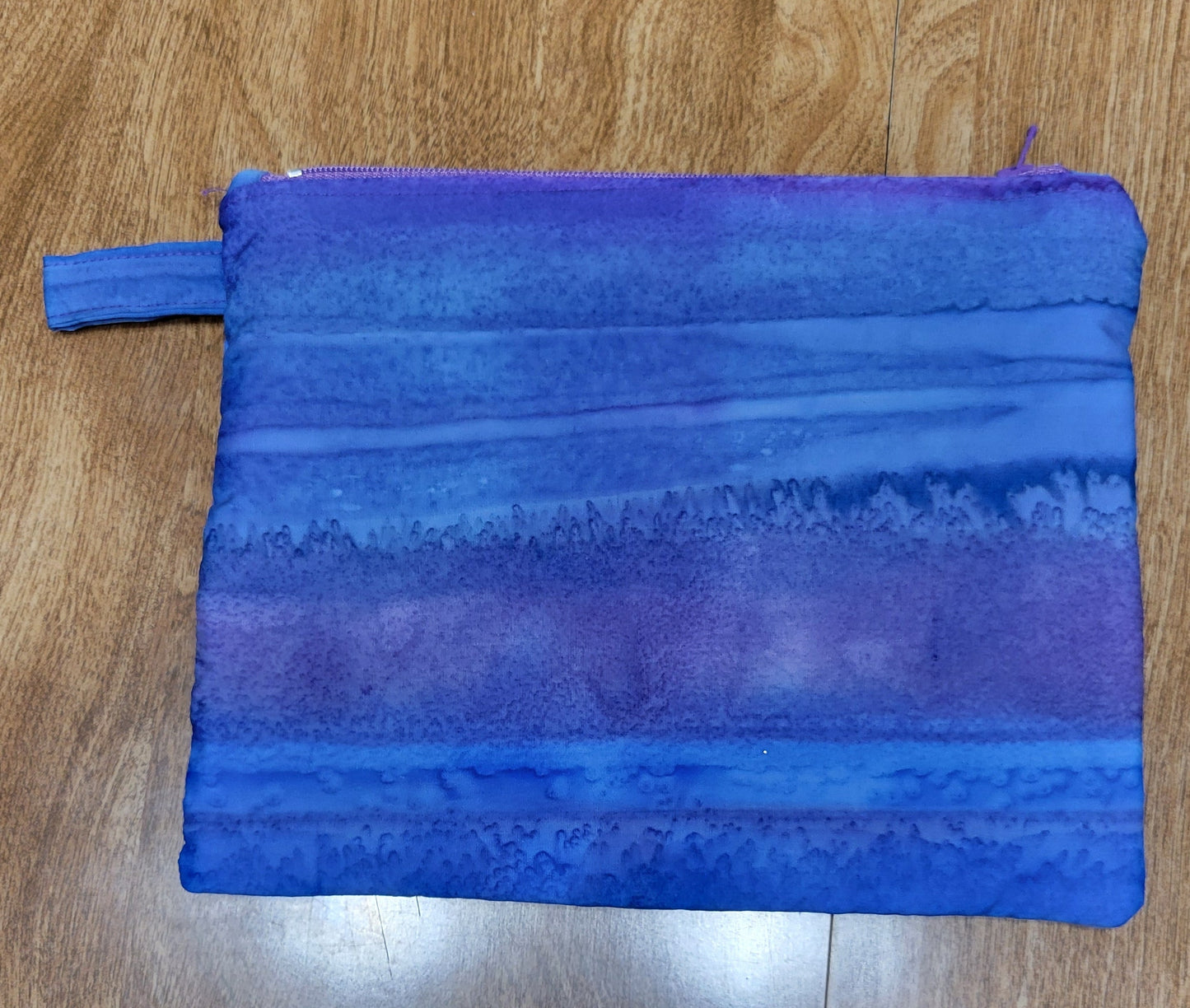 Blue fabric pouch on a wooden surface