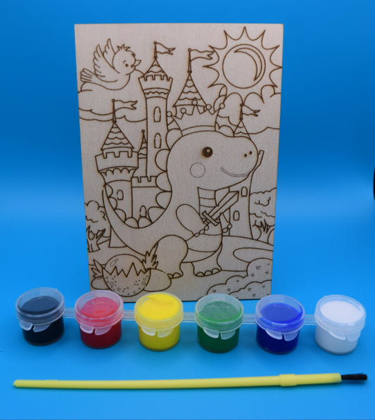 Children's craft kit with a coloring book design of a dinosaur knight a castle and its surroundings, scorn into a 3mm piece of wood, along with paints (black, red, yellow, green, blue and white are provided with a kids paint brush.